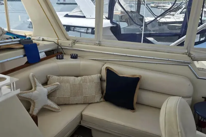 Slide: The Image of Interior of 1987 Chris-Craft 427 Catalina with cozy seating and nautical decor. - 5