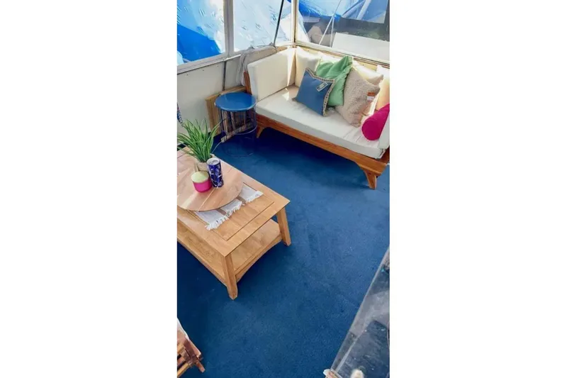 Slide: The Image of Interior of 1987 Chris-Craft 427 Catalina with cozy seating and vibrant decor. - 7