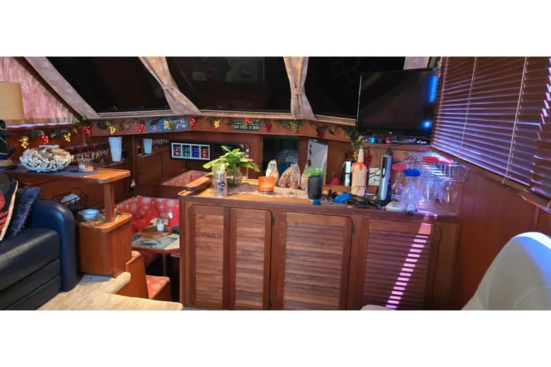 Slide: The Image of Interior of 1987 Chris-Craft 427 Catalina yacht with cozy decor and wooden furnishings. - 8