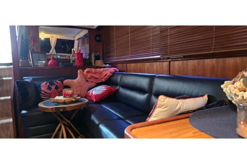 Slide: The Image of Luxurious interior of 1987 Chris-Craft 427 Catalina yacht with cozy seating and nautical decor. - 9