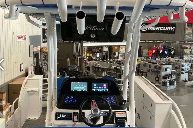 Slide: The Image of Interior view of a 2025 JC SportAngler 26TT HTH boat with advanced dashboard controls. - 10