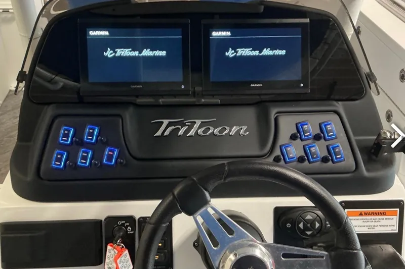 Slide: The Image of Dashboard of 2025 JC SportAngler 26TT HTH boat with dual Garmin displays. - 11