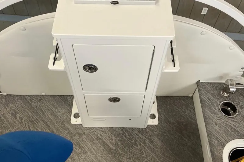 Slide: The Image of Interior view of 2025 JC SportAngler 26TT HTH boat, featuring storage compartments and seating. - 13