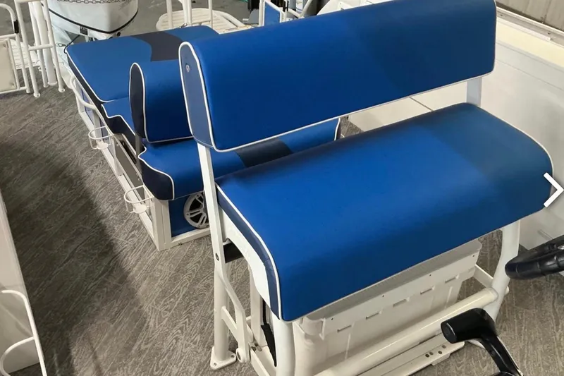 Slide: The Image of Blue seating on 2025 JC SportAngler 26TT HTH boat, featuring white frame and cup holders. - 15