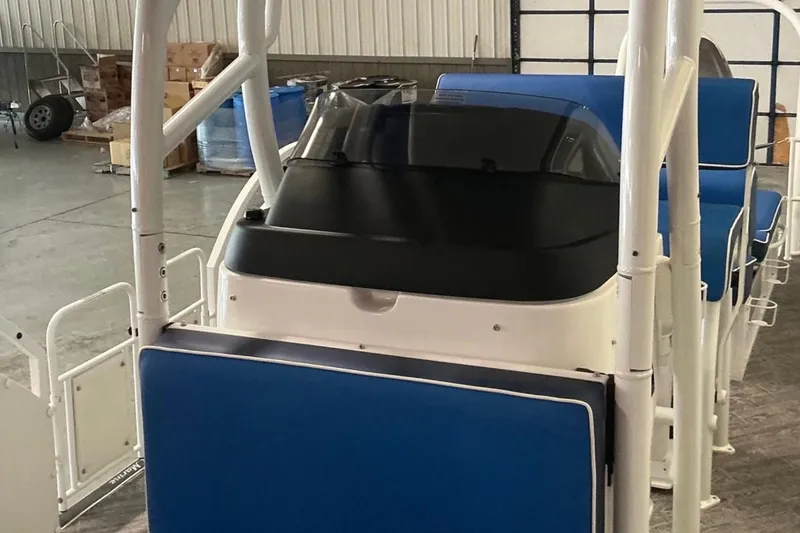 Slide: The Image of 2025 JC SportAngler 26TT HTH boat interior with blue seating and white framework. - 16