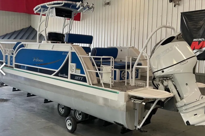 Slide: The Image of 2025 JC SportAngler 26TT HTH pontoon boat with Suzuki outboard motor in a showroom. - 3