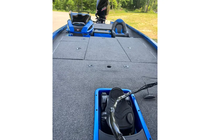 Slide: The Image of 2022 Vexus AVX 2080 boat interior with gray carpet and blue accents. - 12