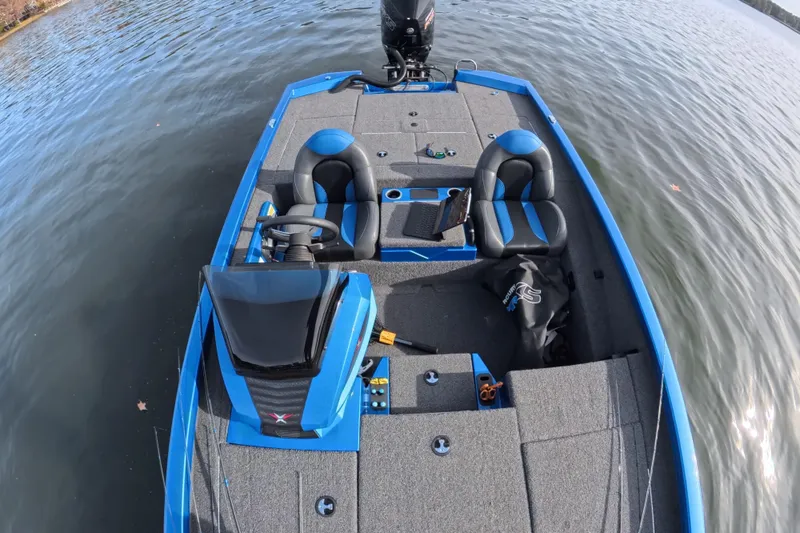 Slide: The Image of 2022 Vexus AVX 2080 boat with blue accents on a calm lake. - 2