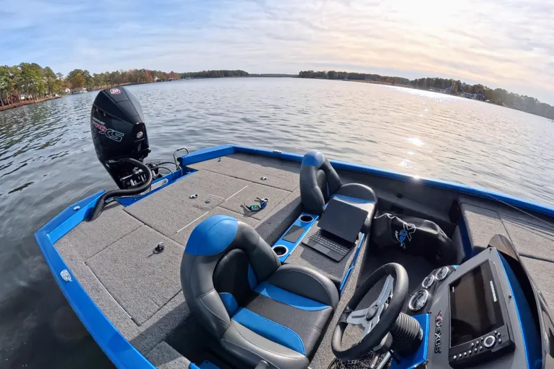 Slide: The Image of 2022 Vexus AVX 2080 boat on a serene lake, featuring modern seating and controls. - 3