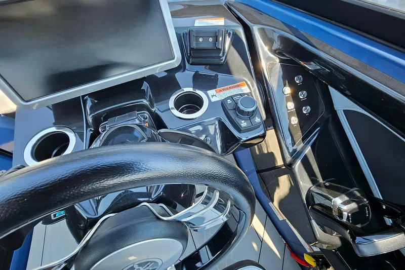 Slide: The Image of Cockpit view of 2023 Yamaha Boats 255XD, featuring steering wheel and control panel. - 10