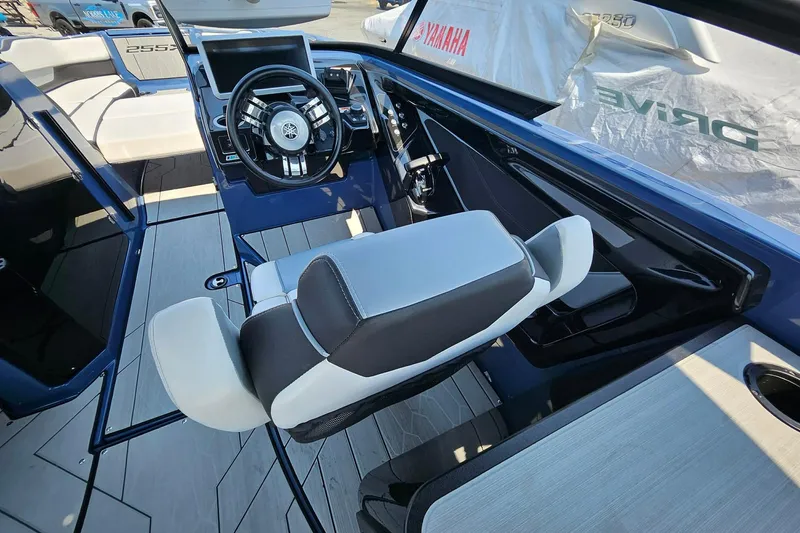 Slide: The Image of Interior view of 2023 Yamaha Boats 255XD, featuring sleek steering and modern seating. - 15