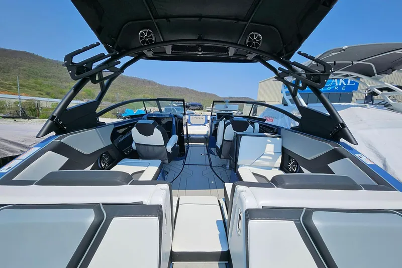 Slide: The Image of 2023 Yamaha Boats 255XD interior with sleek seating and modern design under a clear sky. - 16