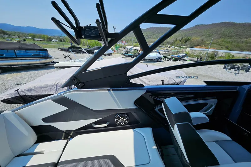Slide: The Image of 2023 Yamaha Boats 255XD interior with sleek design and modern features, parked outdoors. - 5