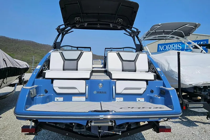 Slide: The Image of 2023 Yamaha Boats 255XD, blue exterior, rear view, luxury seating, parked outdoors. - 6