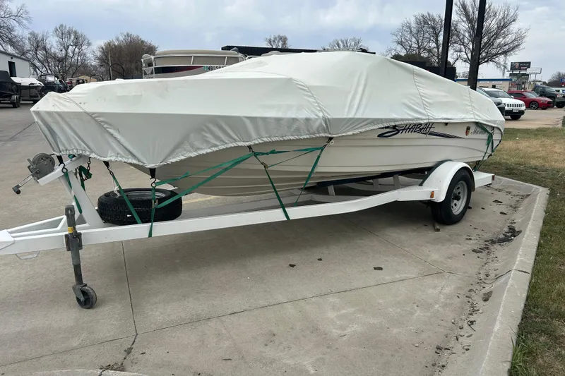 Slide: The Image of Covered 1996 Mariah 180 Shabah boat on trailer, parked on concrete surface. - 13
