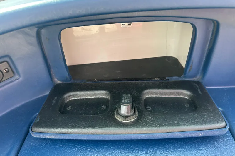 Slide: The Image of Interior compartment of a 1996 Mariah 180 Shabah boat, featuring a storage area. - 18