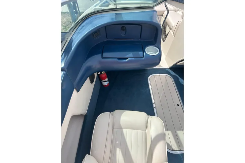 Slide: The Image of Interior of a 1996 Mariah 180 Shabah boat with blue and beige seating. - 19
