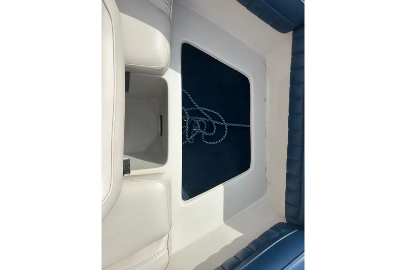 Slide: The Image of Interior view of a 1996 Mariah 180 Shabah boat with seating and storage area. - 21