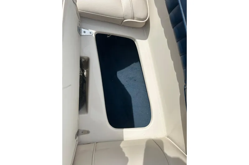 Slide: The Image of Interior view of a 1996 Mariah 180 Shabah boat, featuring beige seating and blue flooring. - 24