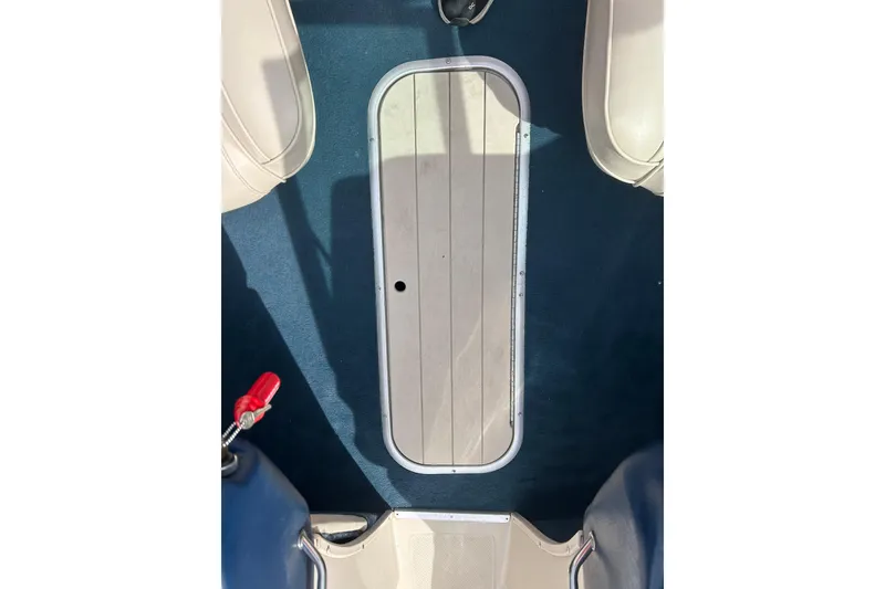 Slide: The Image of Interior view of a 1996 Mariah 180 Shabah boat, featuring a blue carpeted floor. - 26