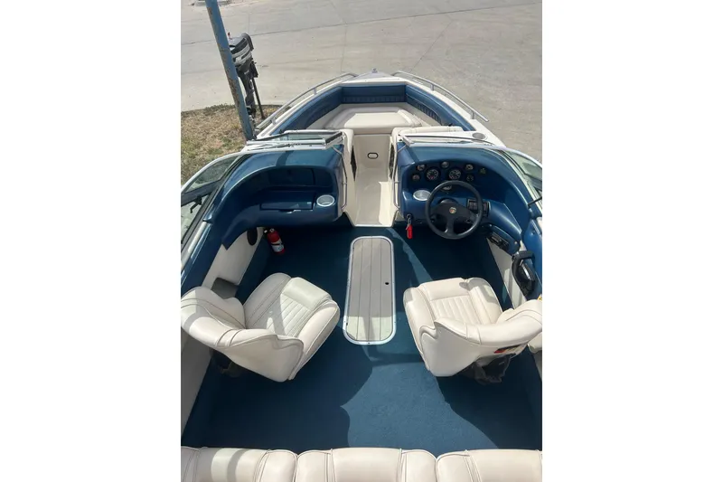 Slide: The Image of 1996 Mariah 180 Shabah boat interior with blue and white seating and dashboard. - 6