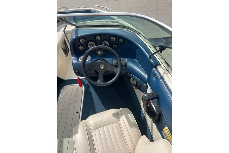 Slide: The Image of 1996 Mariah 180 Shabah boat dashboard with steering wheel and gauges. - 8