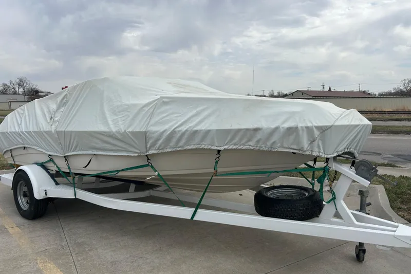 Slide: The Image of Covered 1996 Mariah 180 Shabah boat on trailer, parked outdoors. - 9