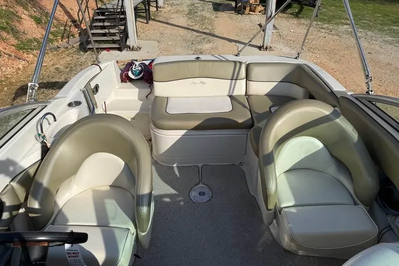 Slide: The Image of Interior of a 2005 Sea Ray 220 Sundeck boat with beige seating. - 14