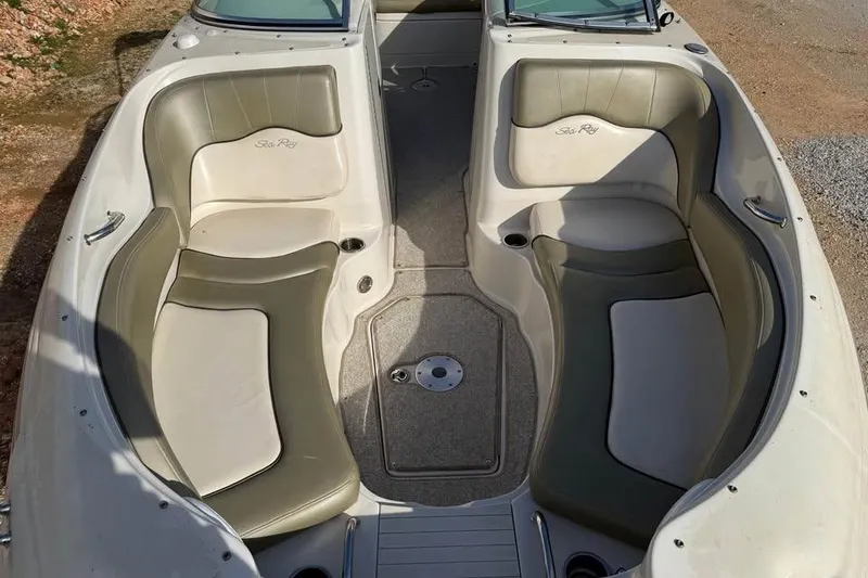 Slide: The Image of 2005 Sea Ray 220 Sundeck boat interior with cushioned seating and carpeted floor. - 15