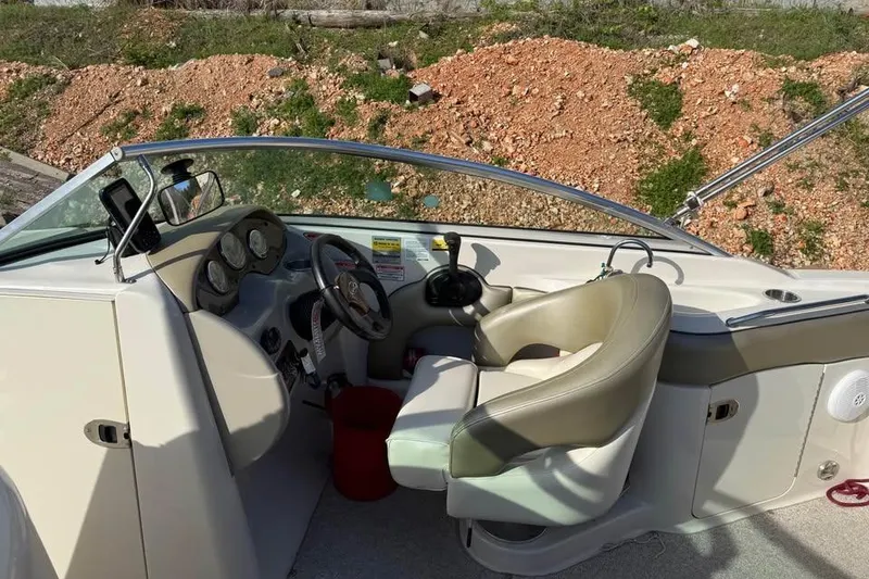 Slide: The Image of Interior view of 2005 Sea Ray 220 Sundeck boat cockpit with steering wheel and controls. - 9