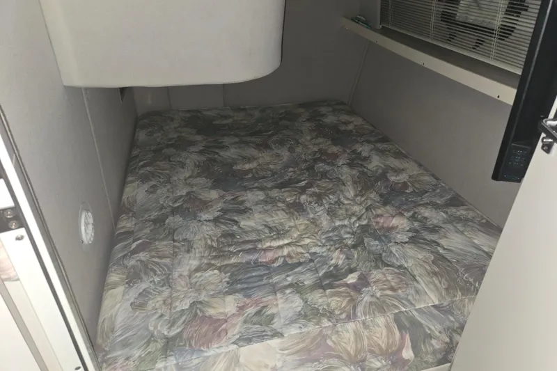 Slide: The Image of Interior cabin of 1994 Cruisers Yachts 3380 Esprit with floral-patterned bedding. - 11