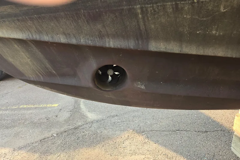 Slide: The Image of 1994 Cruisers Yachts 3380 Esprit hull with visible bow thruster on dry dock. - 18