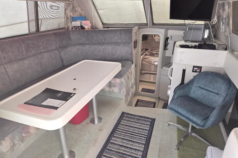 Slide: The Image of Interior of 1994 Cruisers Yachts 3380 Esprit with seating, table, and helm station. - 7