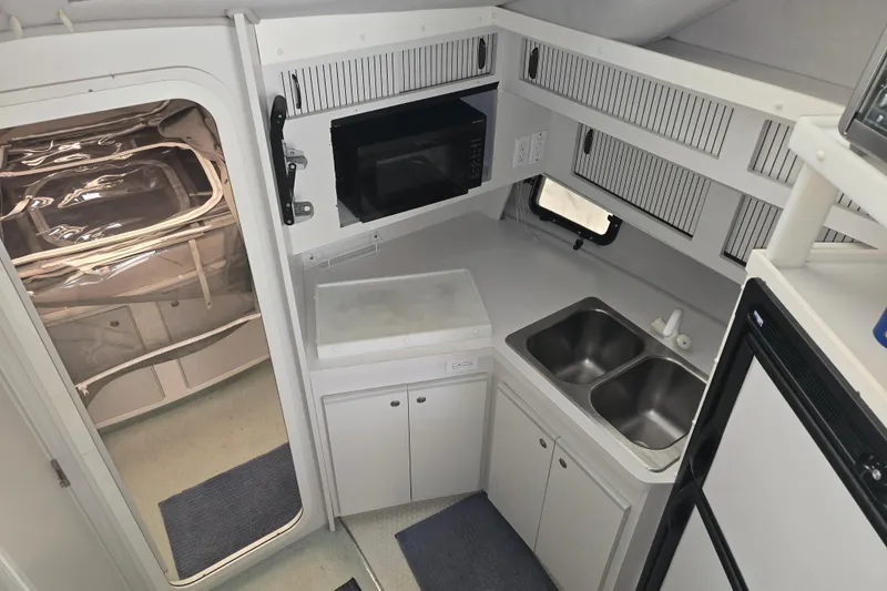 Slide: The Image of 1994 Cruisers Yachts 3380 Esprit galley with microwave, dual sink, and compact design. - 8