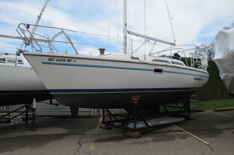 The Image of 1997 Catalina 28 MkII sailboat on a stand, displayed outdoors. - 0