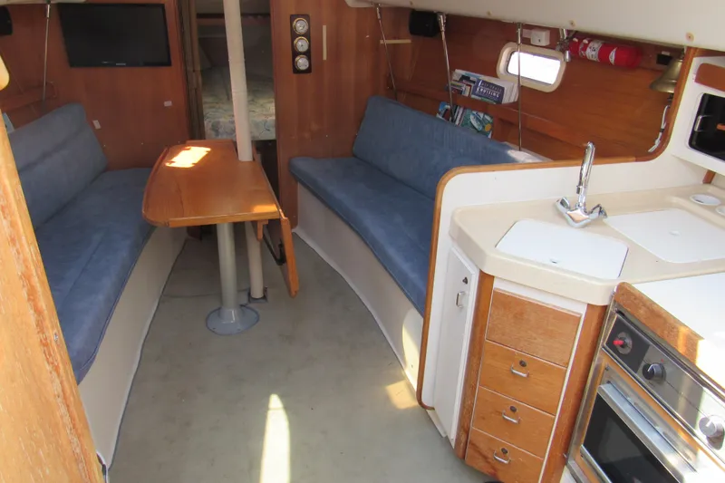 Slide: The Image of Interior of a 1997 Catalina 28 MkII sailboat with kitchen and seating area. - 10