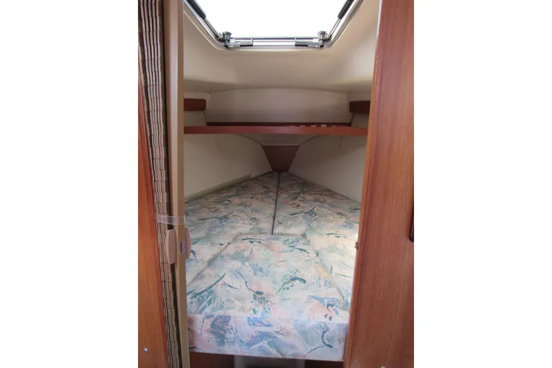 Slide: The Image of Interior cabin of 1997 Catalina 28 MkII sailboat with patterned bedding. - 15