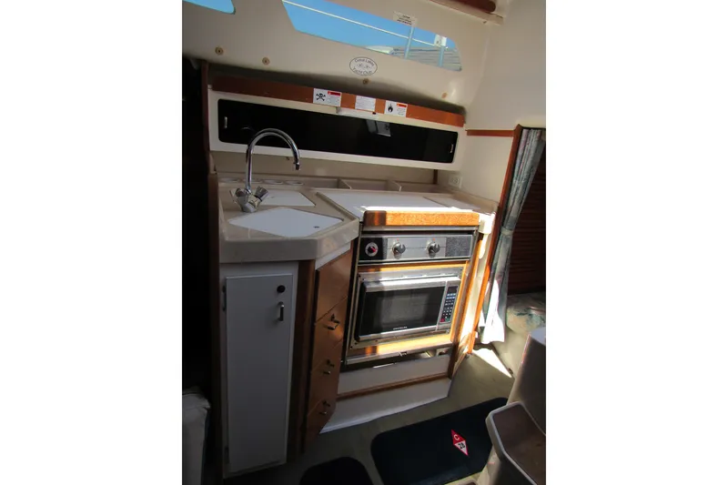 Slide: The Image of 1997 Catalina 28 MkII yacht kitchen with sink, stove, and oven. - 20
