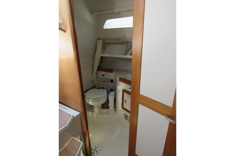 Slide: The Image of Interior view of 1997 Catalina 28 MkII sailboat bathroom with toilet and storage. - 22