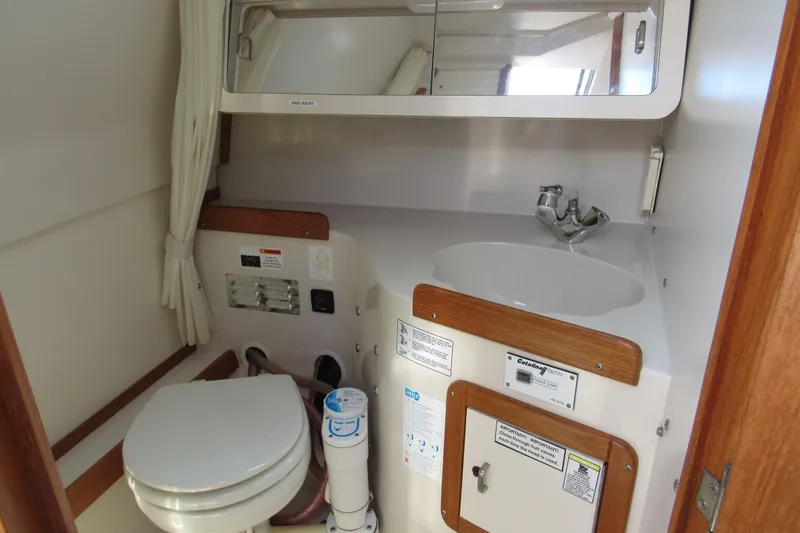 Slide: The Image of Bathroom interior of a 1997 Catalina 28 MkII yacht, featuring a toilet and sink. - 23