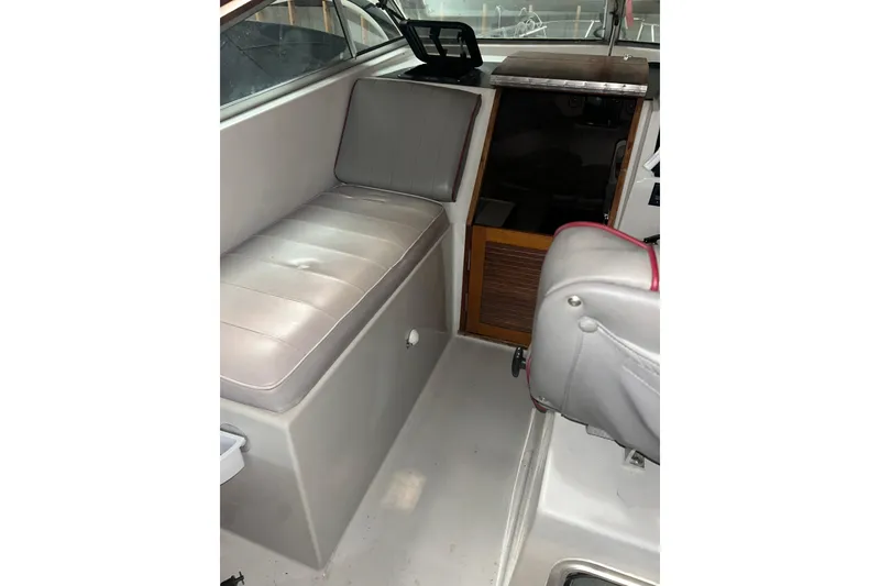 Slide: The Image of Interior of a 1990 Thompson 250 Daytona Mid Cabin boat, featuring seating and cabin entrance. - 15
