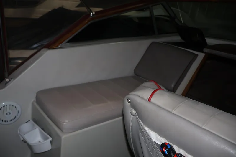 Slide: The Image of Interior of a 1990 Thompson 250 Daytona Mid Cabin boat, featuring cushioned seating. - 22