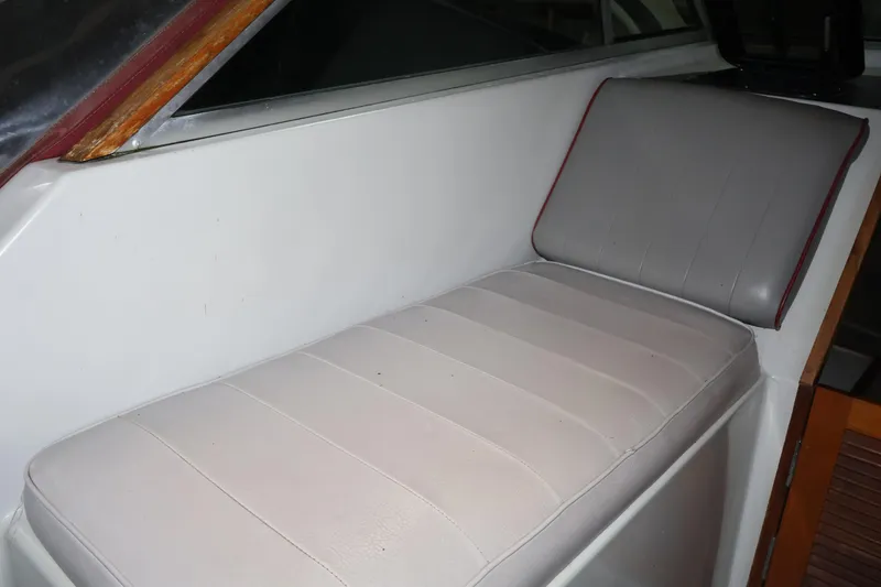 Slide: The Image of 1990 Thompson 250 Daytona Mid Cabin interior seating with white and gray upholstery. - 23