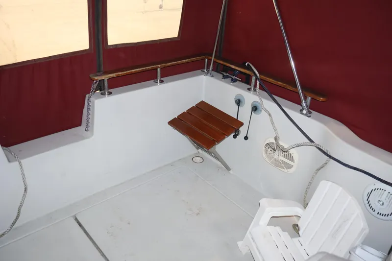 Slide: The Image of 1990 Thompson 250 Daytona Mid Cabin interior with red canopy and seating area. - 31