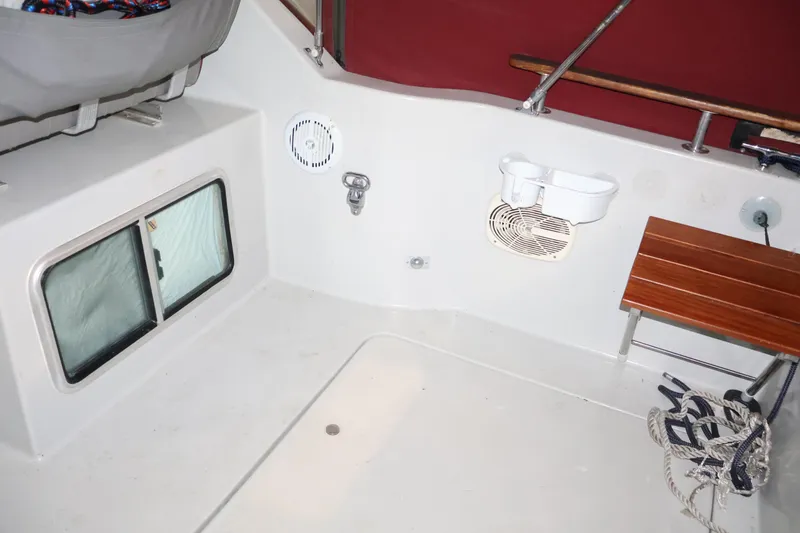 Slide: The Image of Interior of 1990 Thompson 250 Daytona Mid Cabin boat with seating and storage. - 33