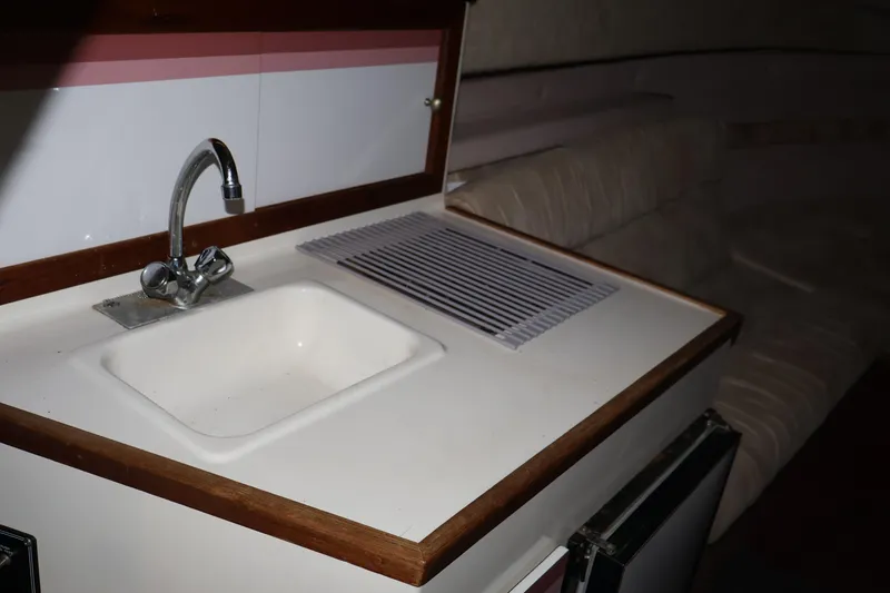 Slide: The Image of Interior of 1990 Thompson 250 Daytona Mid Cabin with sink and seating area. - 35