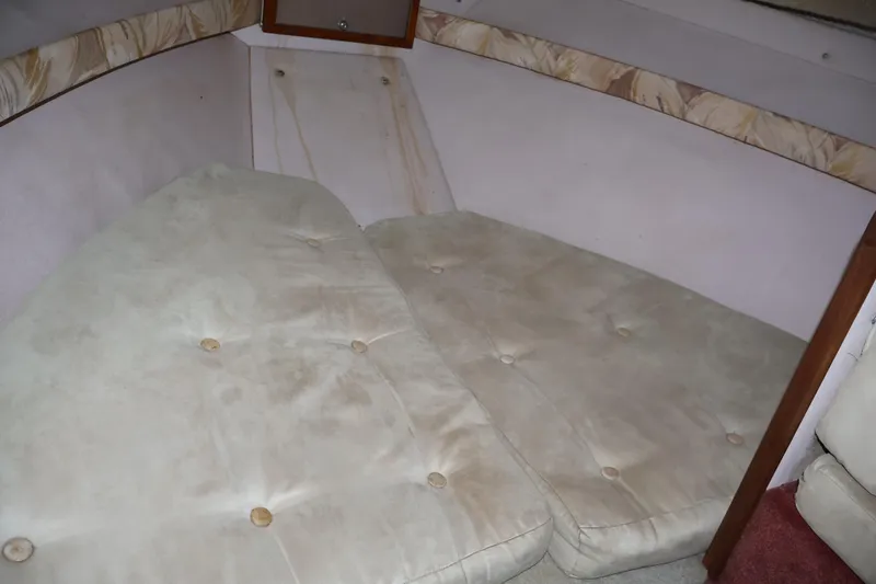 Slide: The Image of 1990 Thompson 250 Daytona Mid Cabin interior with cushioned seating area. - 37