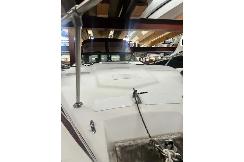 Slide: The Image of 1990 Thompson 250 Daytona Mid Cabin boat in storage, view of bow and windshield. - 7