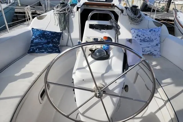 Slide: The Image of Cockpit of a 1998 Hunter 310 sailboat with steering wheel and nautical decor. - 3