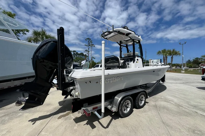 Slide: The Image of 2022 Everglades 243 Center Console boat on trailer under a partly cloudy sky. - 10